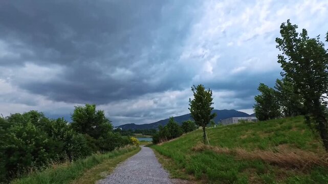 Walking Through Green Park Path Under Dramatic Cloud Cover, Brescia, Italy - POV VIDEO - NO AUDIO