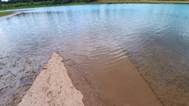 Concrete Walkway Leading to Scenic Quarry Lake View (Fast Transition), Brescia, Italy - TILT UP VIDEO - NO AUDIO