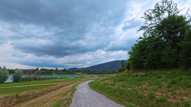 Walking Along Park Trail Beneath Dark Clouds and Flying Birds, Brescia, Italy - POV VIDEO