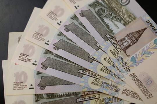Close-up of Russian 10 rouble banknotes, top view. Stack of ten rouble banknotes, macro top view