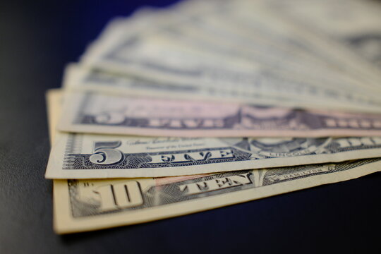  Dollar banknotes from 1 to 10 dollars, close-up top view. US dollar banknotes in 1, 2, 5 and 10 dollar denominations, top view