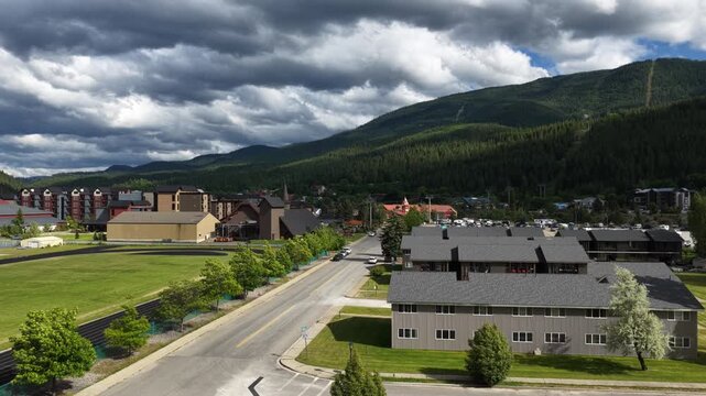 Aerial of Kellogg Idaho small town area near Coeur Dalene National Forest with overcast skies and ski resort in spring