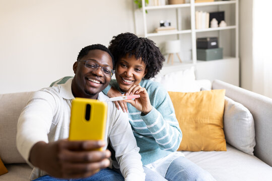 Happy sharing pregnancy test result on video call at home