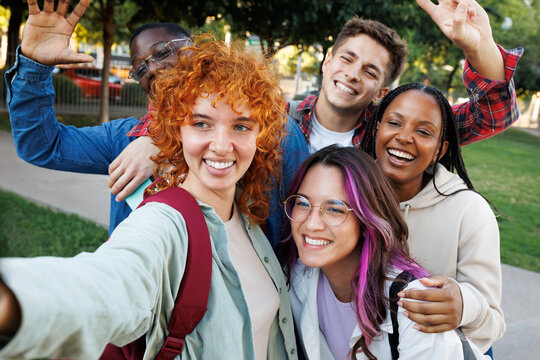 Group of cheerful diverse students taking a selfie together on campussmili
