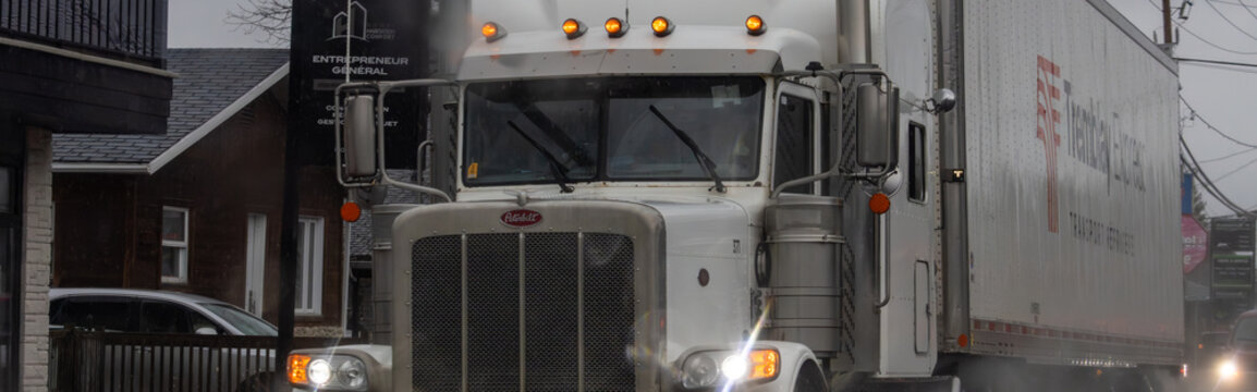 Canada, 13 April 2026 : Peterbilt semi-truck with Tremblay Express Transport Services trailer travels on a street
