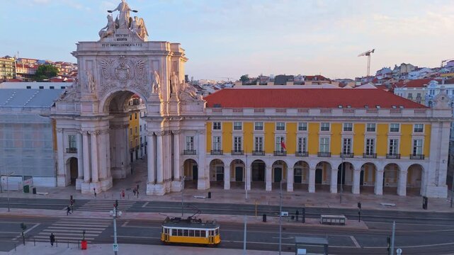 Lisbon City in the Morning. Empty Commerce Plaza, Old Traditional Historic Tram and Rua Augusta Arch. Portugal. Aerial Drone Shot. Moving Sideways