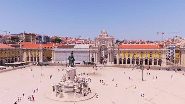 Lisbon City on Sunny Day. Commerce Plaza, Equestrian Statue, Tourists and Rua Augusta Arch. Portugal. Aerial Drone Shot. Orbiting