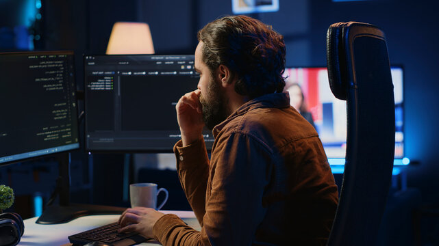 Stressed engineer feeling pressed by deadline, thinking how to finish developing code on PC, IT specialist brainstorming ways of solving database errors, working hard, drinking coffee.