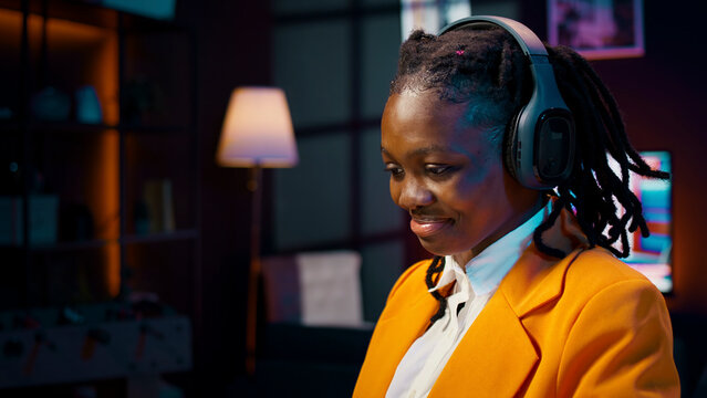 Young woman participating in online debate forums or academic competitions to learn case studies relevant to university coursework, African american girl listening to web webinar.