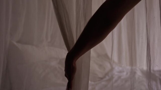 Woman Opening Mosquito Net and Inviting Partner to Relax in Bed. Cozy Morning, Romance and Tropical Vacation Lifestyle