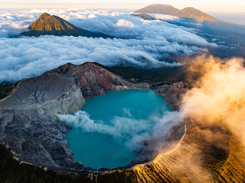 Aerial view of rock cliff at Kawah Ijen volcano with turquoise sulfur water lake at sunrise.Amazing nature landscape view at East Java, Indonesia. Natural landscape background