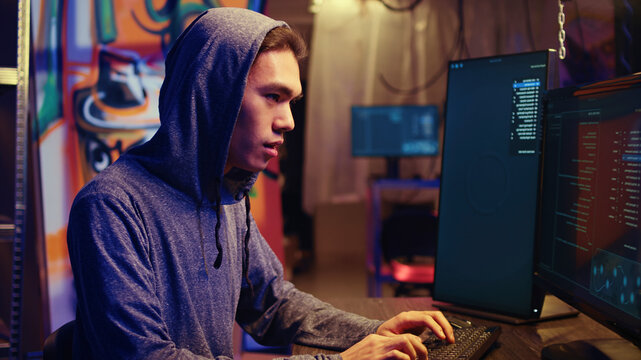 Hacker excited after finally developing zero day exploit undetectable by antivirus software installed on systems, Rogue programmer happy to successfully trick firewalls, close-up.