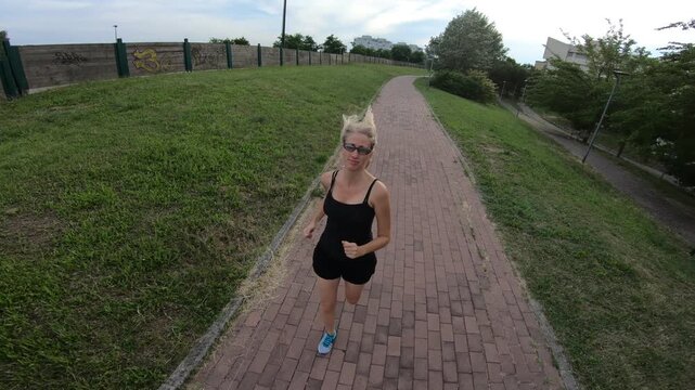 girl dressed exercise gear running in park, symbolizing a healthy lifestyle. female jogger on a countryside pathway, depicting a fit lifestyle. concept of healthy life cardio jogging workout outdoors