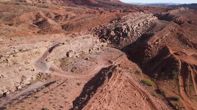 Aerial Drone View Rising Over Utah Desert Bluff with Red Rocks and Sand Dunes