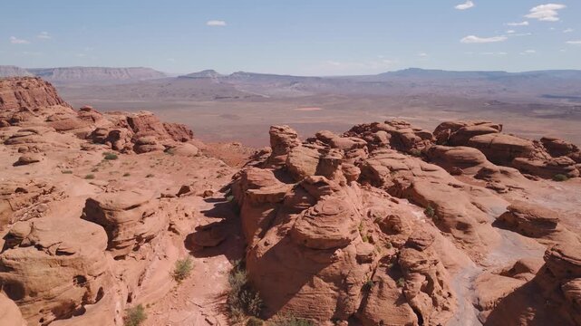 Aerial Drone View Rising Over Utah Desert Bluff with Red Rocks and Sand Dunes