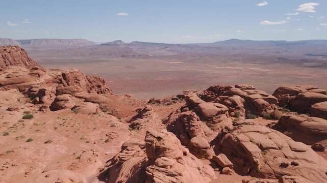 Aerial Drone View Rising Over Utah Desert Bluff with Red Rocks and Sand Dunes