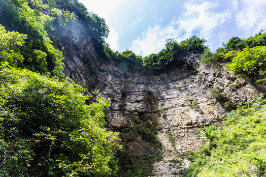 Shuanghe Cave Entrance, Zunyi China with Limestone Cliffs and Vegetation