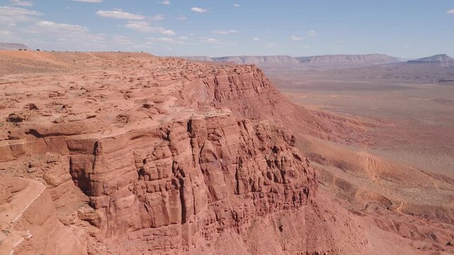 Aerial Drone View Rising Over Utah Desert Bluff with Red Rocks and Sand Dunes
