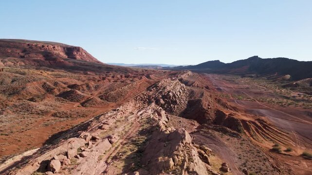 Aerial Drone View Rising Over Utah Desert Bluff with Red Rocks and Sand Dunes
