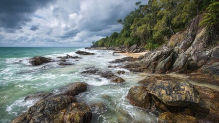 Fototapeta premium Rugged coastline with waves crashing against rocky shores and lush green trees