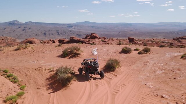 Aerial Drone View of UTVs Offroading on Red Rock Desert Trails in Utah