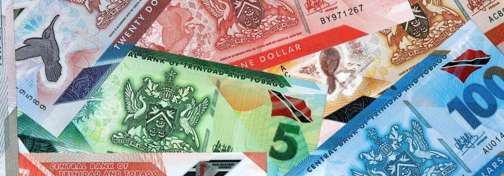 Trinidad and Tobago dollar money banknotes bunch on table. Trinidad and Tobago bills of TTD currency