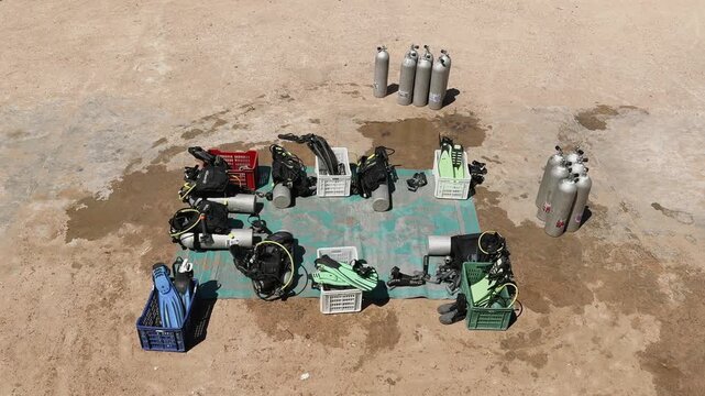 Scuba diving equipment prepared for tourist group before reef dive