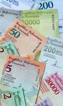 Venezuelan bolivar money bills in pile on table. Venezuela VES currency cash close up