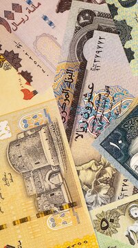 Yemeni rial money bills in pile on table. Yemen YER currency cash close up