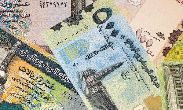 Yemeni rial money bills in pile on table. Yemen YER currency cash close up