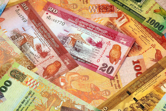 Sri Lankan rupee money bills in pile on table. Sri Lanka LKR currency cash close up