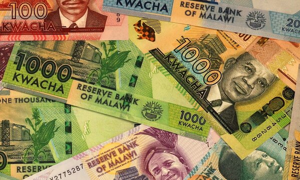 Malawian kwacha money bills in pile on table. Malawi MWK currency cash close up
