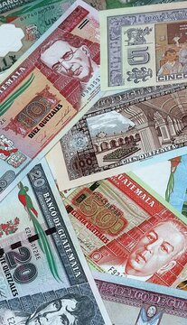 Guatemalan quetzal money bills in pile. Big amount of Guatemala GTQ currency cash close up