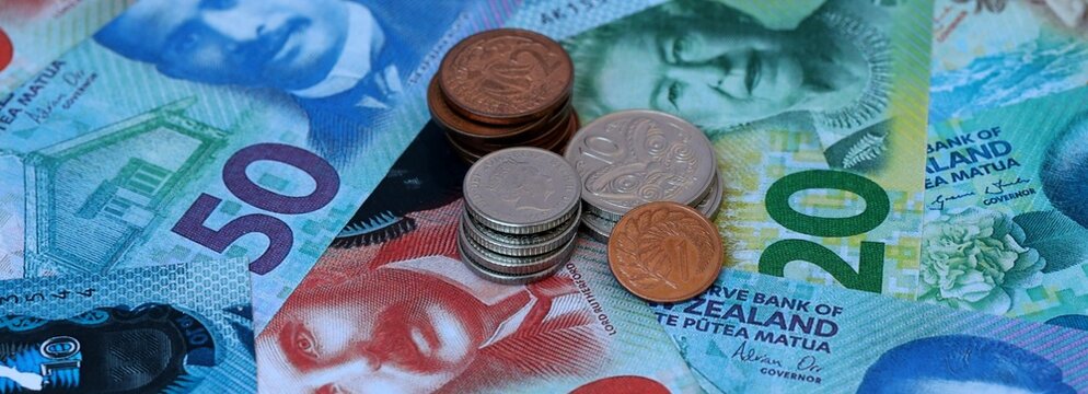 New Zealand dollar money banknotes and coins on table. New Zealand cash bills of NZD currency