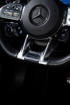 Mercedes CLA 45 S steering wheel AMG badge closeup, Luxury sport sedan interior branding detail
