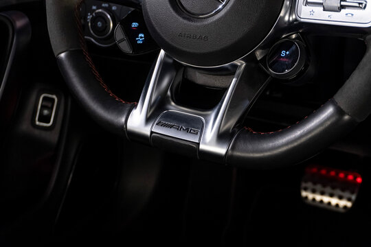 Mercedes CLA 45 S steering wheel AMG badge closeup, Luxury sport sedan interior branding detail