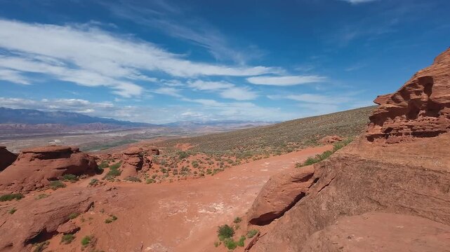 FPV Drone Cinematic Flight Around Desert Rock Pillars with UTVs and People Camping