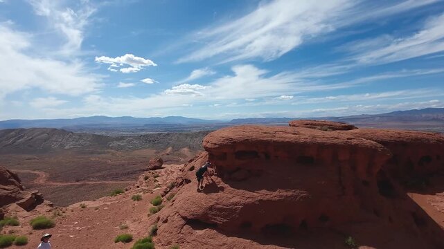 FPV Drone Cinematic Flight Around Desert Rock Pillars with UTVs and People Camping