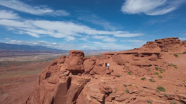 FPV Drone Cinematic Flight Around Desert Rock Pillars with UTVs and People Camping