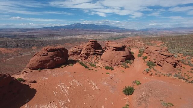 FPV Drone Cinematic Flight Around Desert Rock Pillars with UTVs and People Camping