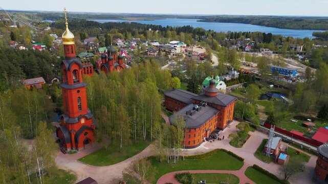 Traditional orthodox cathedral red brick church building with golden dome aerial panorama view.
