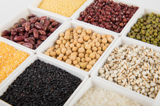 Assorted whole grains and legumes in white bowls