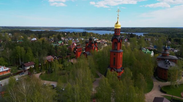 Traditional orthodox cathedral red brick church building with golden dome aerial panorama view.
