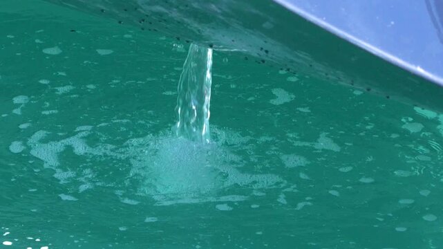 Close Up of Bilge Pump Water Discharging from Boat Hull