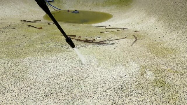 High Pressure Water Jet Cleaning Algae from Concrete Swimming Pool