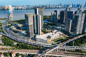 Aerial View of Wuhan Riverside Skyline, Bridge and Urban School Campus © NguyenMinh