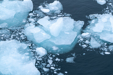 Aerial view of melting icebergs floating in the arctic ocean © Corbin
