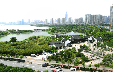 Urban skyline and wetland park with traditional Chinese buildings by the waterfront © HoangNgoc