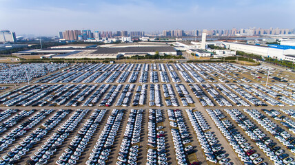 Aerial view of massive automobile storage lot beside industrial factory complex © HoangNgoc