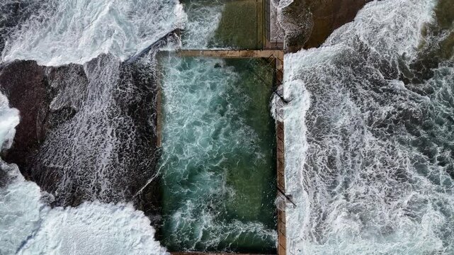 Drone video aerial view of a beach rock pool near a beach in Sydney Australia in Summer on vacation 
